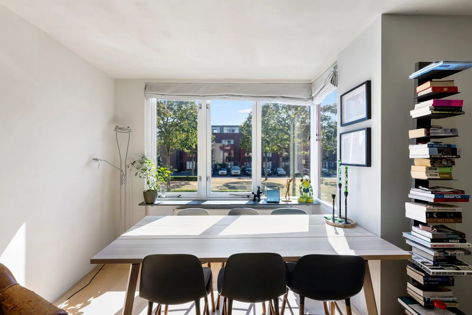 Eetkamer in de erker, met zwarte stoelen rond de tafel